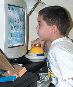 Boy using a specially adapted computer for his vision