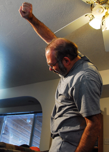 Man raising his arm overhead for a stretch