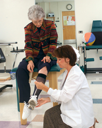 Physical therapist adjusts a leg brace