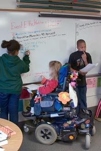Kids working at the board in class