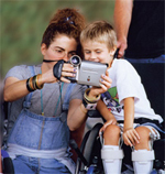 Woman and boy using video camera