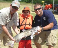 Camper fishing with volunteers