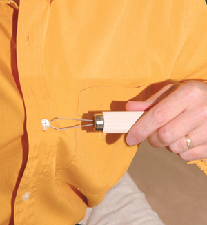 Man demonstrating a button hook