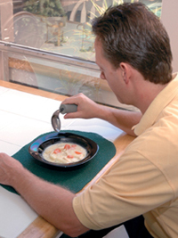 Man using an offset eating utensil