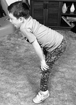 Boy performing Gowers maneuver