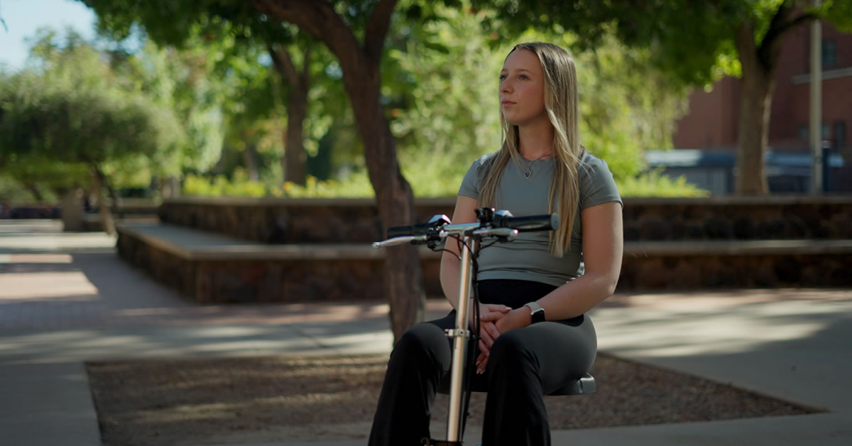 Image of a woman in a wheelchair at a university outside.